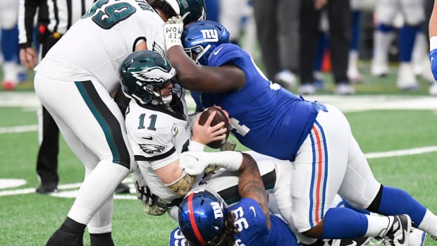 New York Giants defensive end Leonard Williams (99) and lineman Dalvin Tomlinson (94) sack Philadelphia Eagles quarterback Carson Wentz (11) in the second half. The Giants defeat the Eagles, 27-17, at MetLife Stadium on Sunday, Nov. 15, 2020.